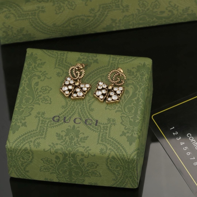G*u*i earrings